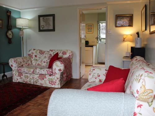 a living room with two chairs and a couch at Thorncliffe Cottage in Tideswell