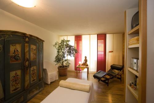 a living room with a couch and a chair at Appartement-Hotel Seespitz in Füssen
