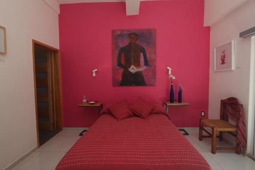 Postel nebo postele na pokoji v ubytování LARIMAR Gallery y Hotel Boutique