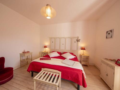 a bedroom with a large bed with a red blanket at Maison d'époque avec sauna, jacuzzi et salle de jeux à 1h de Paris - Idéale familles/amateurs de stages - FR-1-590-4 in Boisseaux