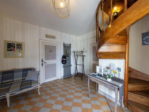 a room with a staircase and a couch and a table at Maison d'époque avec sauna, jacuzzi et salle de jeux à 1h de Paris - Idéale familles/amateurs de stages - FR-1-590-4 in Boisseaux