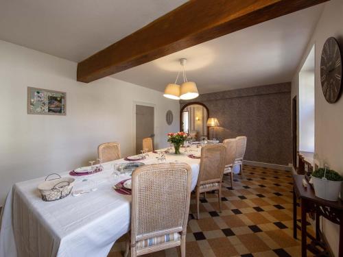 a dining room with a long table and chairs at Maison d'époque avec sauna, jacuzzi et salle de jeux à 1h de Paris - Idéale familles/amateurs de stages - FR-1-590-4 in Boisseaux