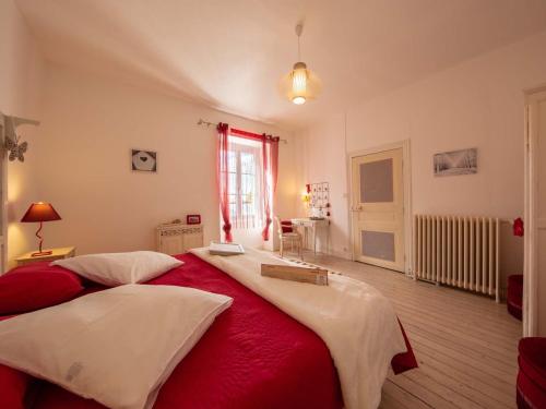 a bedroom with two beds with red and white sheets at Maison d'époque avec sauna, jacuzzi et salle de jeux à 1h de Paris - Idéale familles/amateurs de stages - FR-1-590-4 in Boisseaux