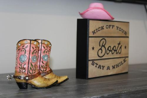 a figurine of a pair of boots next to a box at Luxury in the Gulch in Nashville