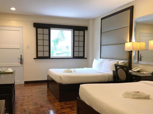 Postel nebo postele na pokoji v ubytování Jinjiang Inn - Boracay Station 1