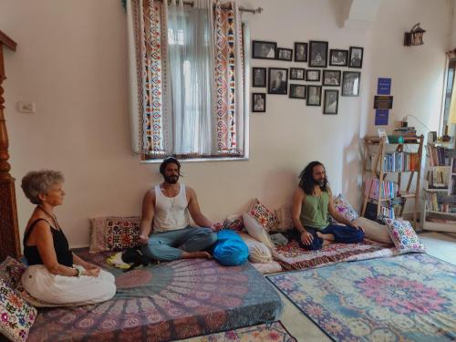 a group of people sitting on the floor in a room at TantraLoka Retreat Centre in Arambol