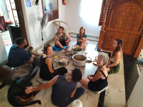 a group of people sitting on the floor in a room at TantraLoka Retreat Centre in Arambol