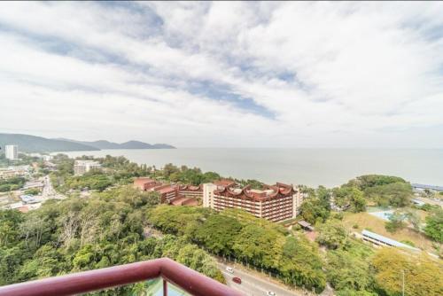 a view of the ocean from the balcony of a resort at Batu Ferringhi Luxury Seaview Suite - 3Br in Batu Ferringhi