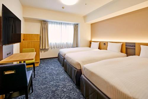 Postel nebo postele na pokoji v ubytování Hotel Lumiere Kasai