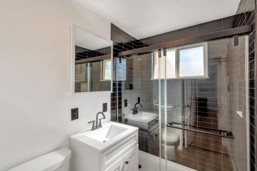 a bathroom with a sink and a toilet and a shower at Renovated 4br w/game room to entertain Near DT in Lakewood