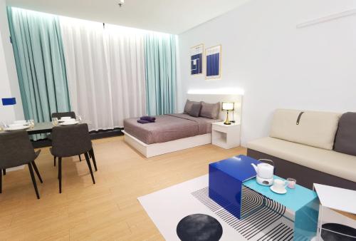 a living room with a couch and a bed at The Blueprint @ Bangsar South Mid Valley in Kuala Lumpur