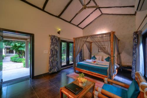 a bedroom with a bed and a living room at Aranyak Resort in Tāla