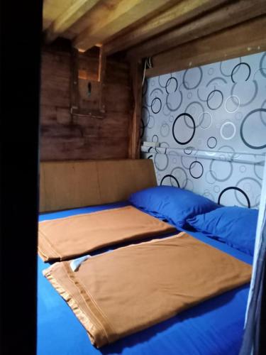 a bedroom with two beds with blue pillows at Liveaboard komodo Tour 2Days 1Night share trip in Labuan Bajo