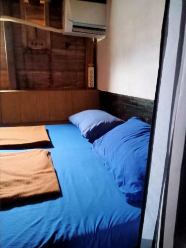 a bedroom with two blue beds in a room at Liveaboard komodo Tour 2Days 1Night share trip in Labuan Bajo
