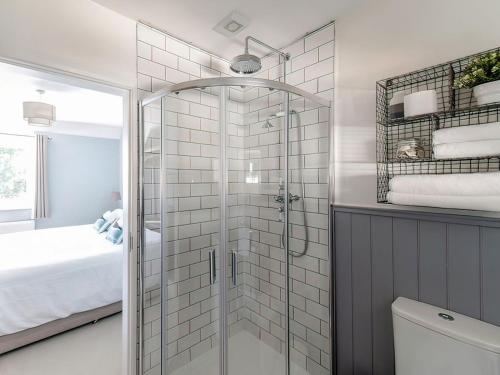 a bathroom with a shower with a glass door at Stanton in Bangor