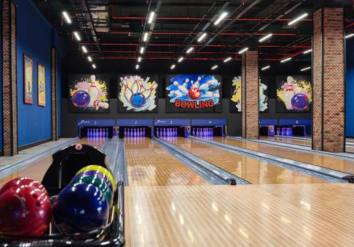 a bowling alley with lanes and balls on the floor at Basqal Resort & SPA in Basqal