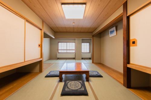 a meditation room with a table and a window at Shiga Kogen Olympic Hotel in Yamanouchi