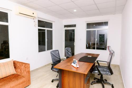 an office with a wooden desk and chairs at Savenndra Resorts in Malwana