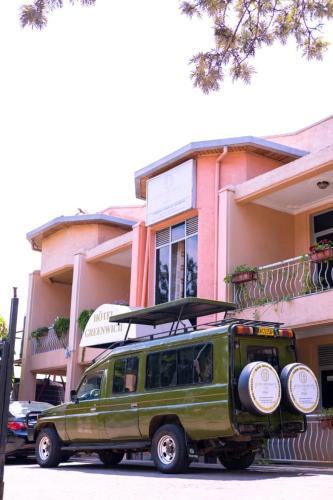 a green van parked in front of a building at Hotel Greenwich in Kigali