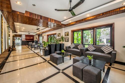 an open living room with couches and tables at The Sanctuary Residence in Siem Reap