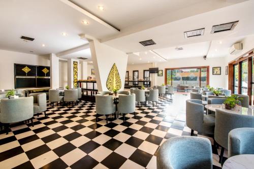 a waiting room at a hotel with chairs and tables at The Sanctuary Residence in Siem Reap