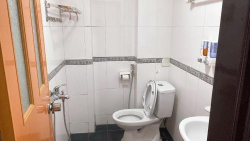 a white bathroom with a toilet and a sink at ESPECEN 38 Thọ Xương in Hanoi