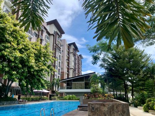 a swimming pool in front of some buildings at Elaiza's Cozy Home - Matina Enclaves Building C Unit 815 in Davao City