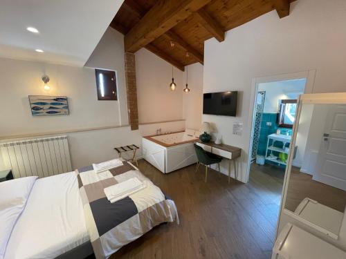 a bedroom with a bed and a bathroom with a sink at B&B Vietri Centro in Vietri sul Mare