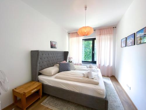 a bedroom with a large bed with a large window at Apartment Aria Velden in Velden am Wörthersee