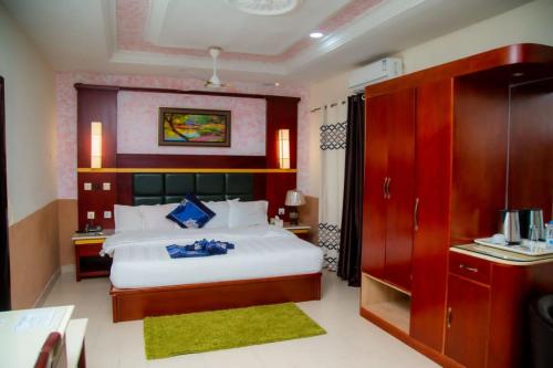 a bedroom with a large bed in a room at Best Lodge in Tamale