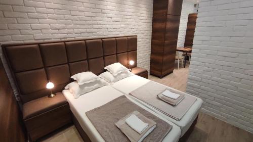 a bedroom with a large bed and a couch at Sky is the limit * Novi Sad * in Novi Sad