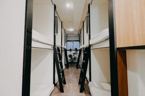 a corridor of a dorm room with bunk beds at unito light SHIMBASHI in Tokyo