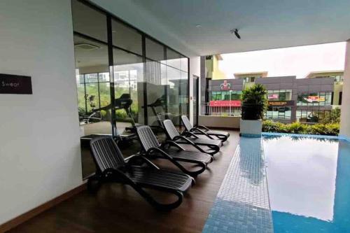 a row of chairs sitting next to a swimming pool at 16 Sierra Puchong Zentro 5 人 Supreme二房公寓 in Puchong
