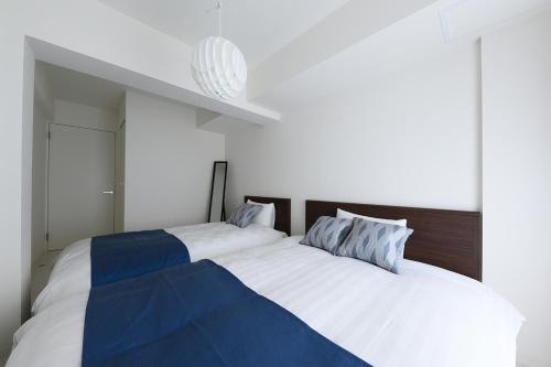 Ένα ή περισσότερα κρεβάτια σε δωμάτιο στο GLASS山鼻 EAST