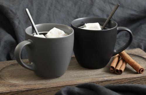 two black cups filled with marshmallows and cinnamon sticks at The Stables at The Black Horse in Willington