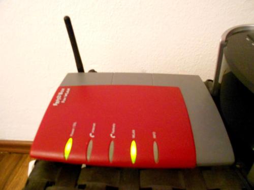 a red and white computer mouse sitting on a table at Apartment Beethoven in Regensburg