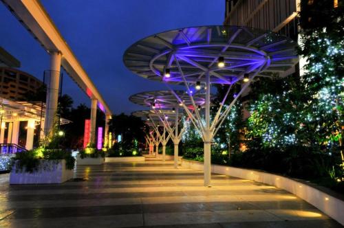 a group of trees with purple lights on a sidewalk at The Shore Hotel & Residences By Lá VISTA in Melaka
