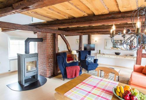 a living room with a wood stove in a room at Ferienhaus Fischerglück im Herzen von Plau am See in Plau am See