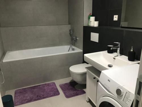 a bathroom with a white toilet and a sink at Apartment Premium in Prague