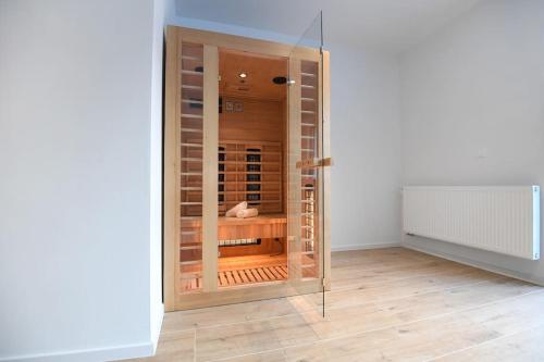 a room with a glass room with a wine cellar at VIlla Luka - new isolated villa with heated pool, jacuzi and sauna in Gračac