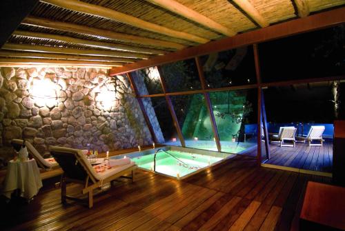 a house with a pool in the middle of a room at Rio Sagrado, A Belmond Hotel, Sacred Valley in Urubamba