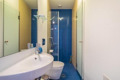 a bathroom with a sink and a toilet and a shower at Villa Escola da Bica in Arco da Calheta