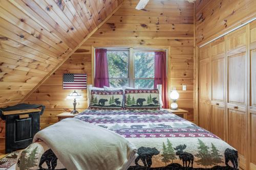 a bedroom with a bed in a log cabin at Rocky Road Retreat in Ellijay