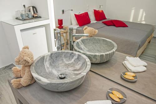 a bathroom with a large tub and a bed at Margarita Studios Ambelas in Ambelas