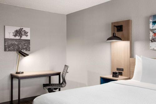 a hotel room with a bed and a desk at La Quinta Inn by Wyndham Temple in Temple