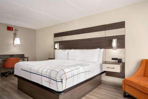a hotel room with a bed and a desk at La Quinta Inn Lexington-Horse Park in Lexington