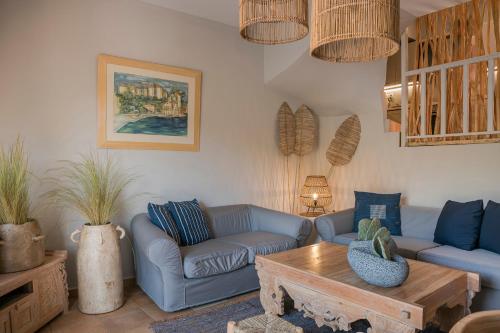 a living room with blue couches and a coffee table at Braunis Horio Villas in Asos