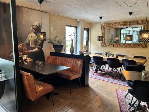 a restaurant with a man painting on the wall at Chalet in Lochem near Forest & Cycling in Lochem