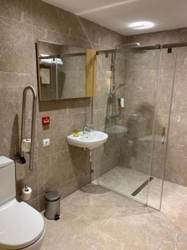 a bathroom with a shower and a sink and a toilet at Sóller Center in Sóller