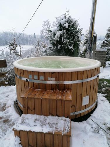 a hot tub covered in snow in a yard at Chalupa Dana in Víchová nad Jizerou